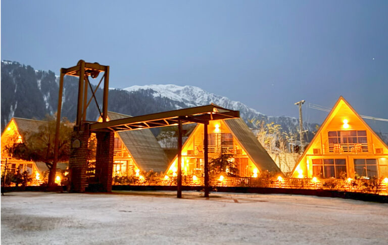 Snow-covered Cedarwood Hotel & Resort surrounded by winter mountains in Shogran.