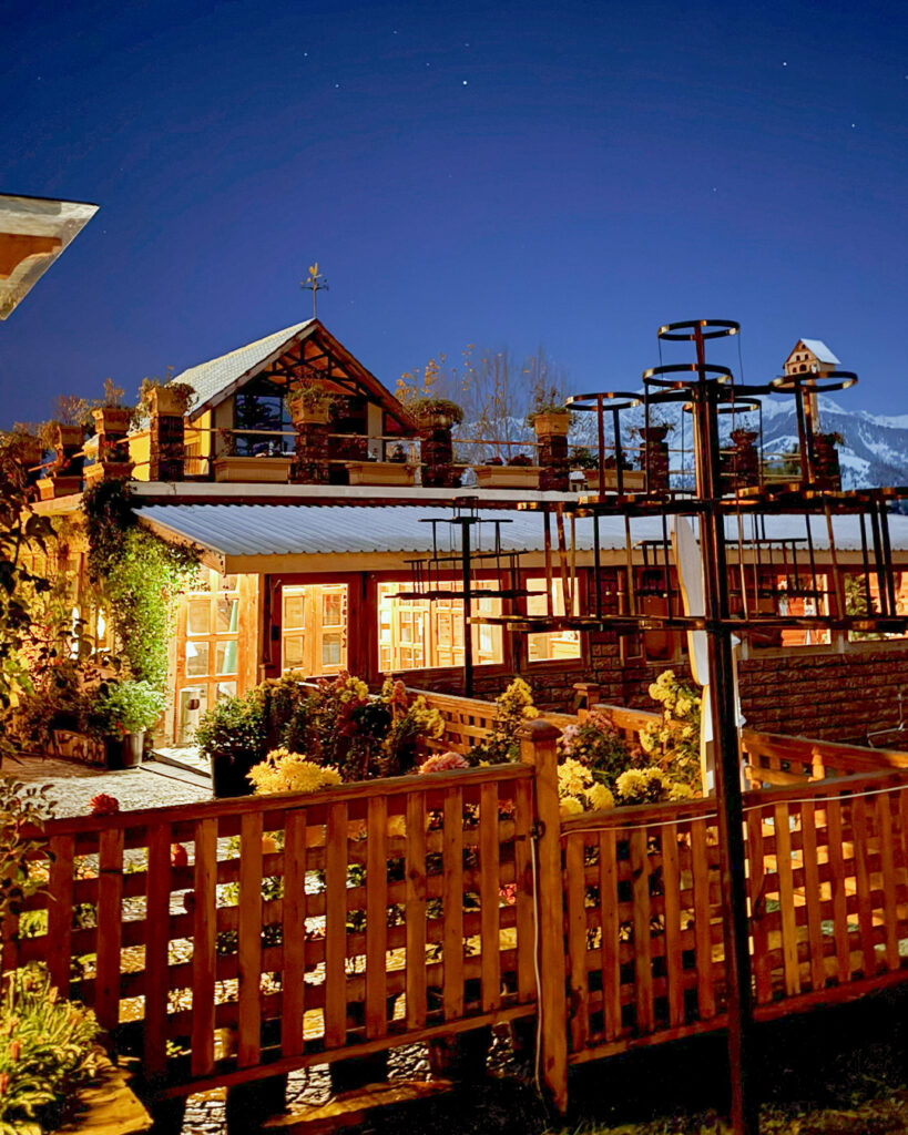 Cozy heated room at Cedarwood Shogran with warm lighting and winter mountain view.